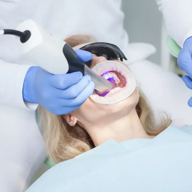 female patient having her teeth scanned by professional dentist (1)